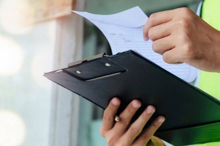 Man inspecting clipboard chart